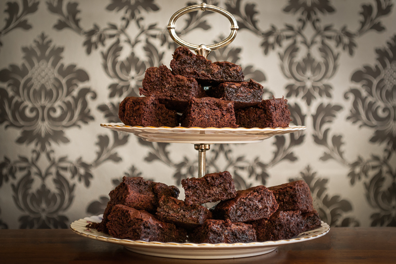 A stack of Gooey Brownies on an Afternoon Tea tiered serving plate